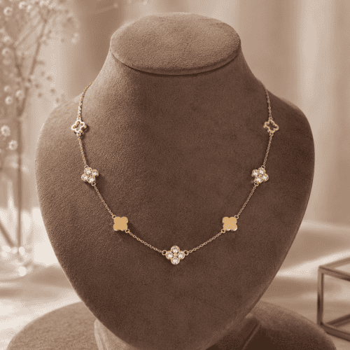 Feiner Goldkettchen mit Blumen- und Kristall-Details auf Schmuckständer.